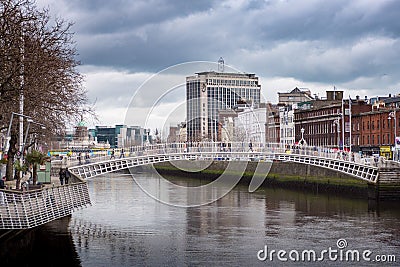 River Liffey, Ha`Penny Bridge and Heineken Building / Oâ€™Connell Bridge House in Dublin, Ireland Editorial Stock Photo